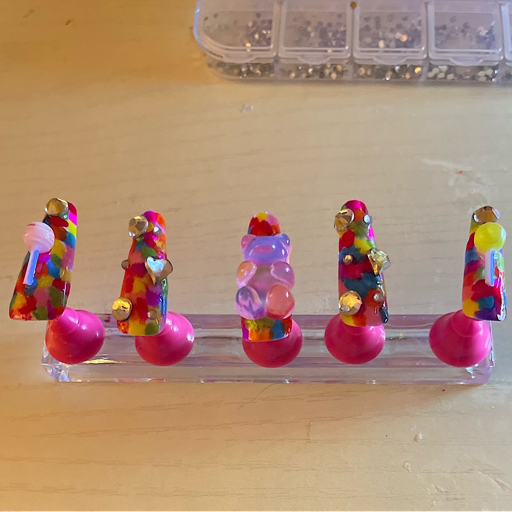 Rainbow square nails with teddy bear and diamonds.